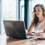 An image of cute girl working on laptopn